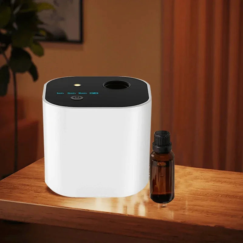 Modern essential oil diffuser and amber bottle on wooden table for clean fresh home air
