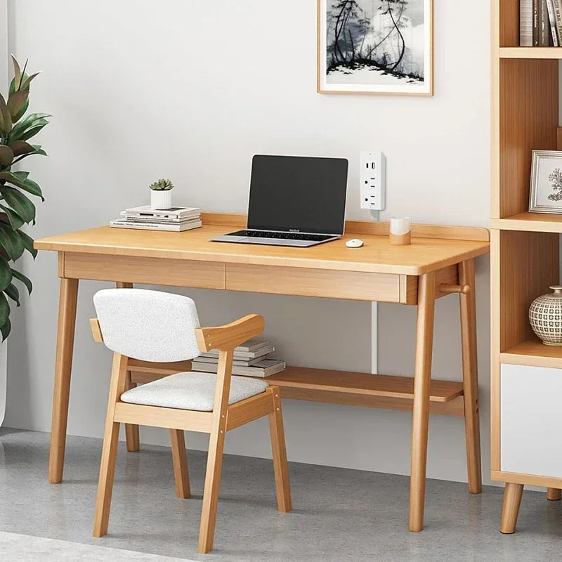 Minimalist wooden desk with laptop, chair, books, and plant in clean modern home office