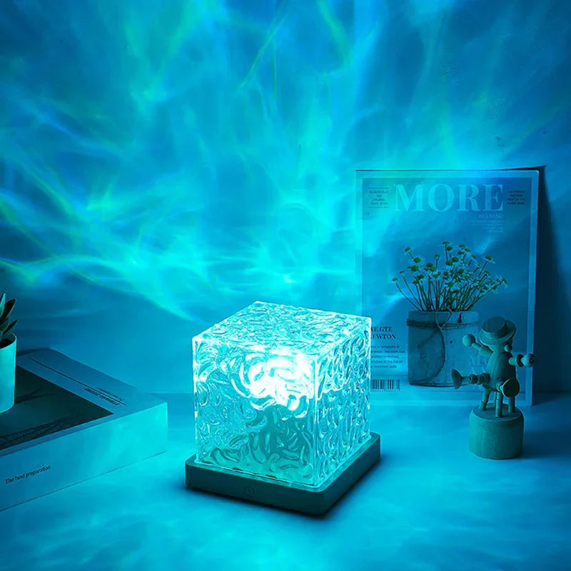 Crystal cube LED night light glowing blue on table, creates relaxing home decor ambiance